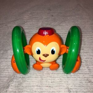 Bright Starts Lights Up and Rolls Orange and Green Monkey Toy
